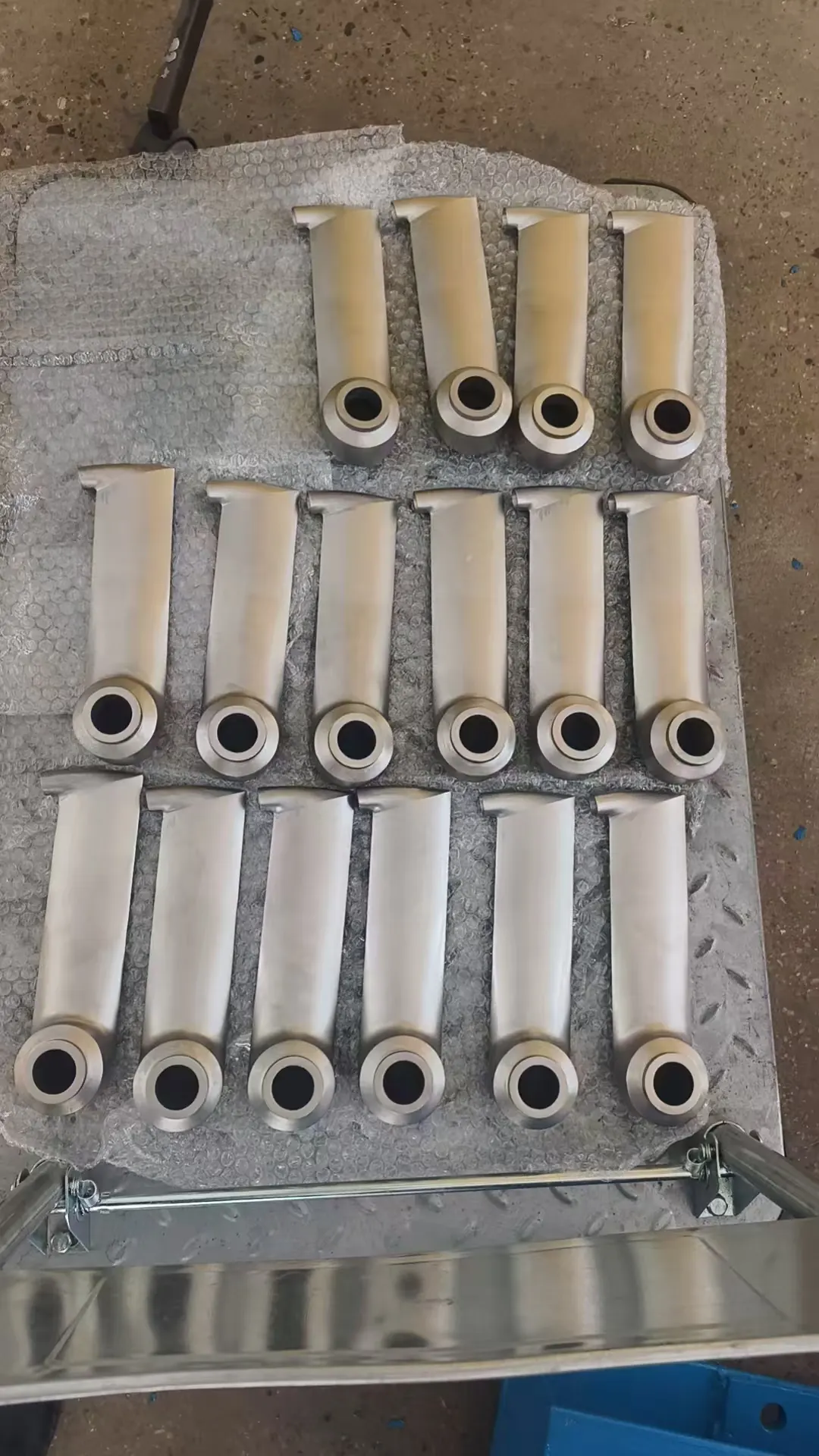 Machined pick-up tube blanks laid out on a pallet