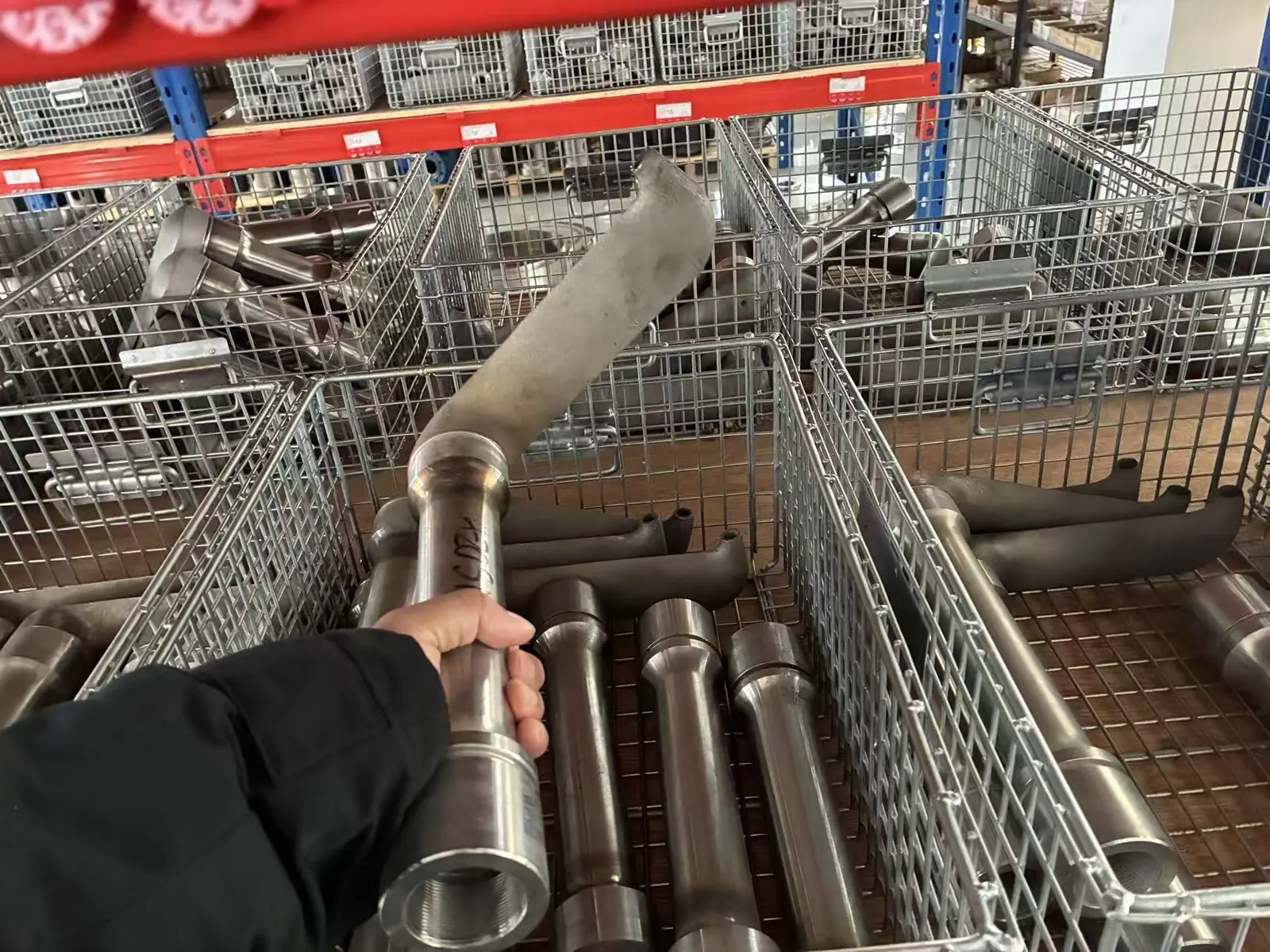 Replacement pitot tube (pick-up tube) held above EHIK parts stock baskets